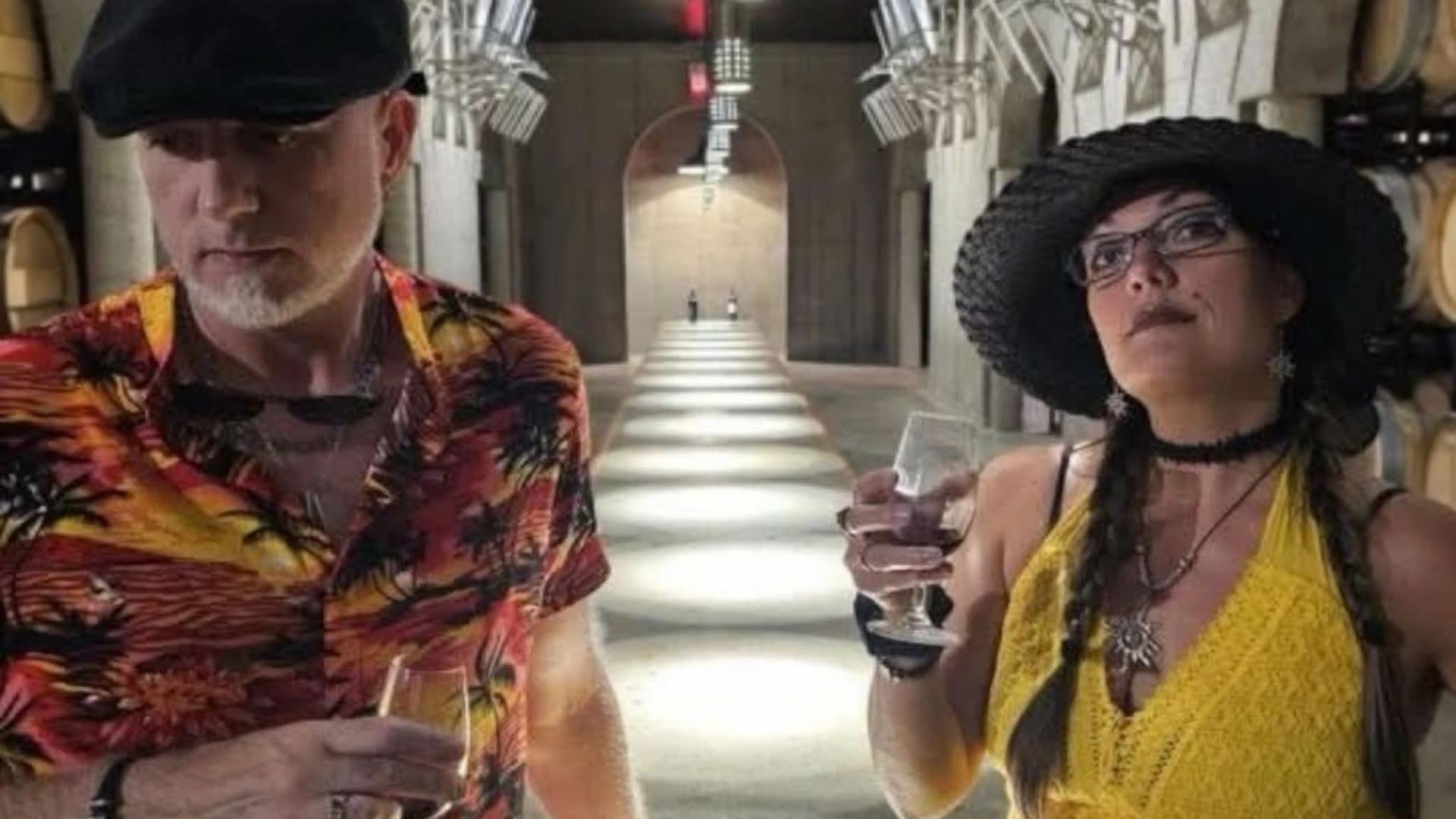 Image of a man in a tropical shirt and a woman in a yellow dress with a summer hat on.