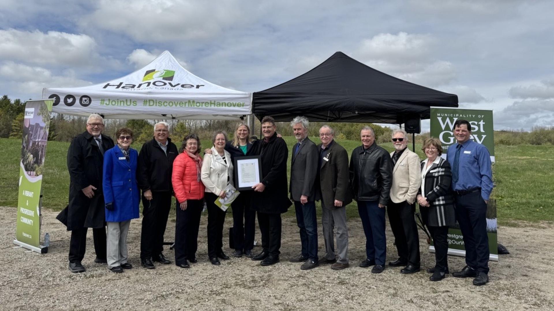 Members of West Grey and Town of Hanover council outside near tents