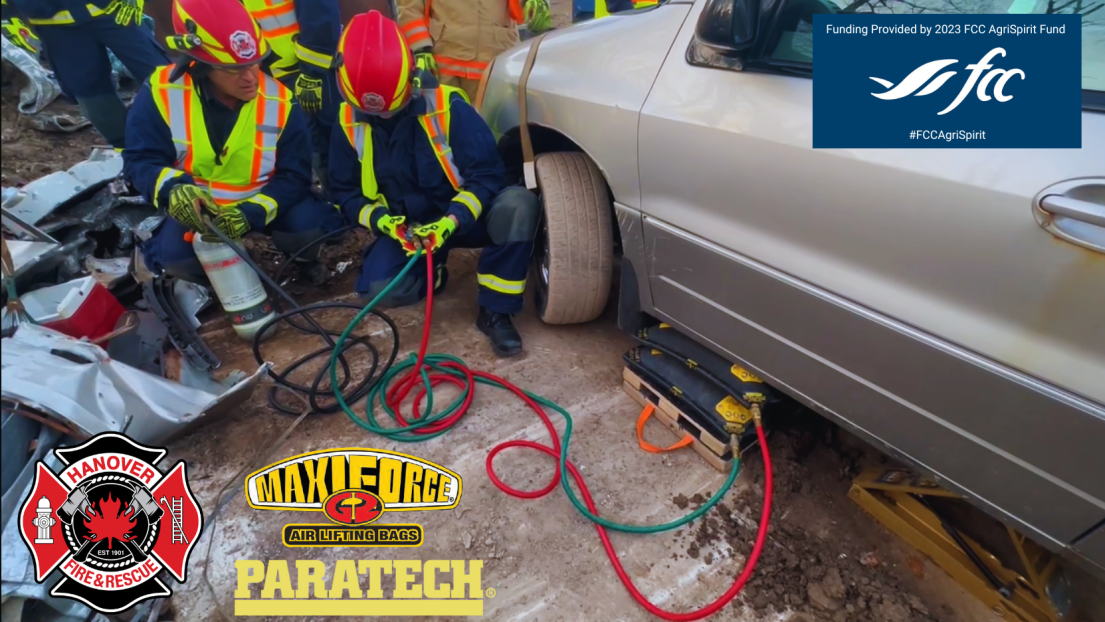 Firefighters using auto extrication equipment on vehicle