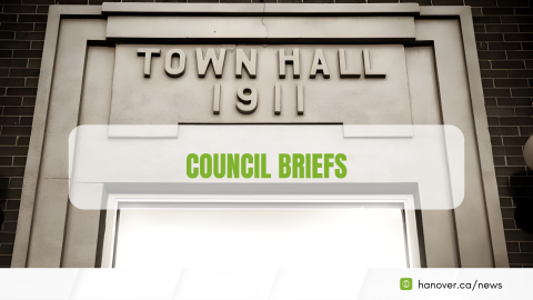 Image of a Town Hall door that says town hall 1911 with text overlayed in light green that says Council Briefs