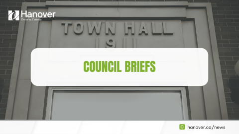 Image of Hanover Town Hall Entrance Sign with Hanover logo in white in top left corner, a dark grey overlay that is transparent and a white bubble that say "Council Briefs" at the bottom right hand corner it says "hanover.ca/news"