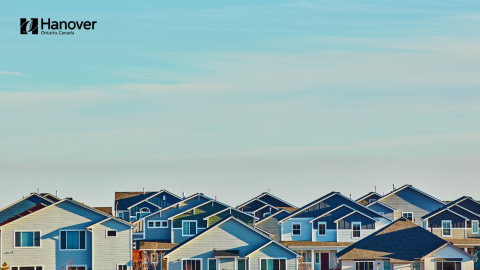 Rows of double story houses with blue sky above and Town of Hanover logo in top left corner