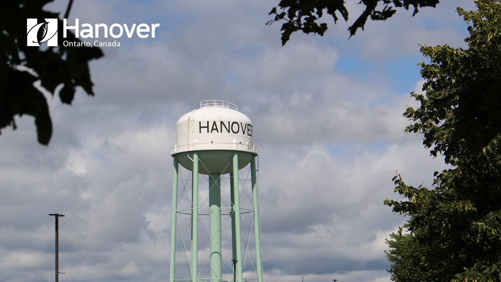 Photo of old water tower with white Hanover logo in top left corner