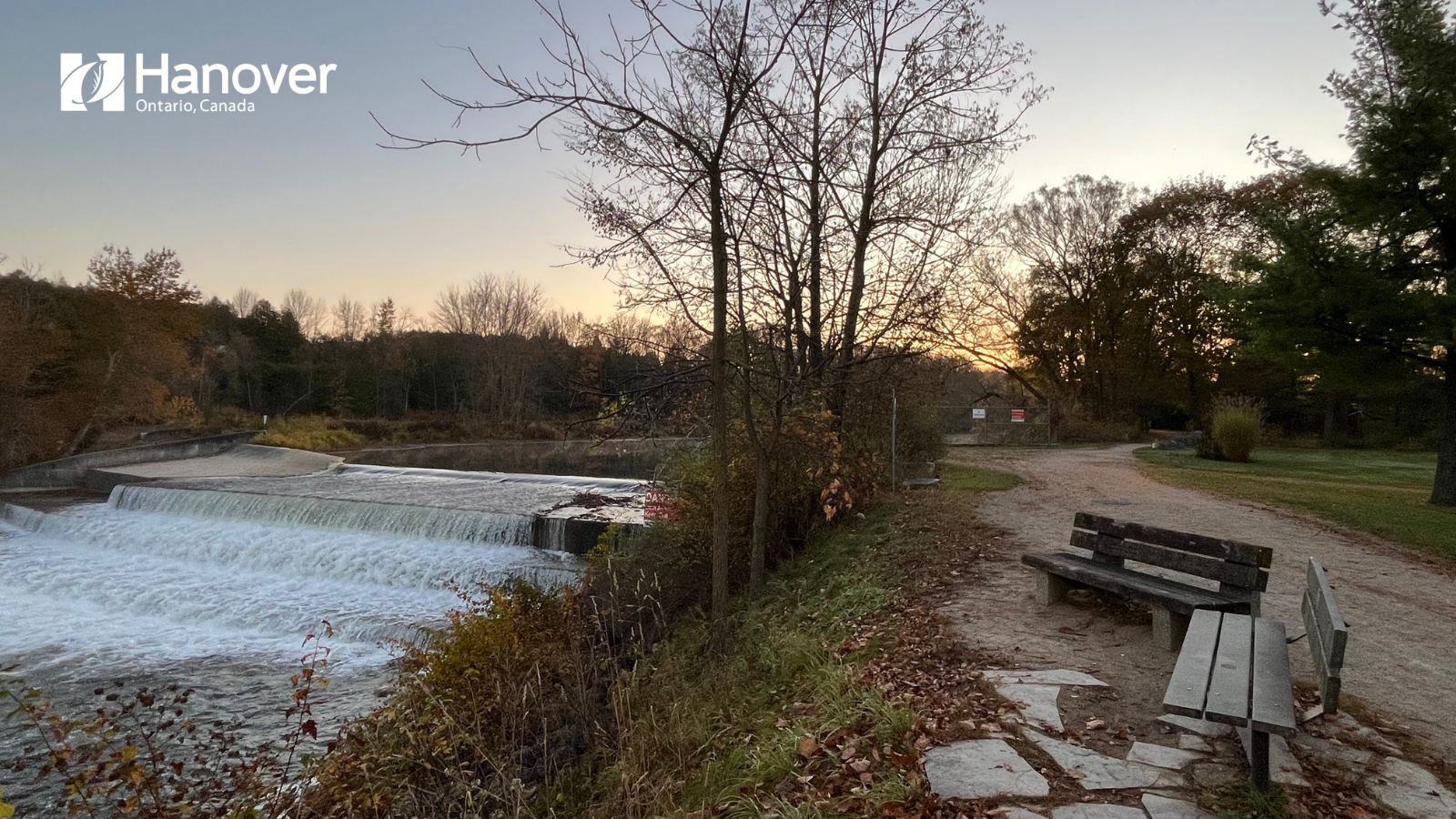 Photo of Hanover Dam at Karl “Speck” Wilken Park & Commemorative Grove with Town of Hanover logo in white at top left corner